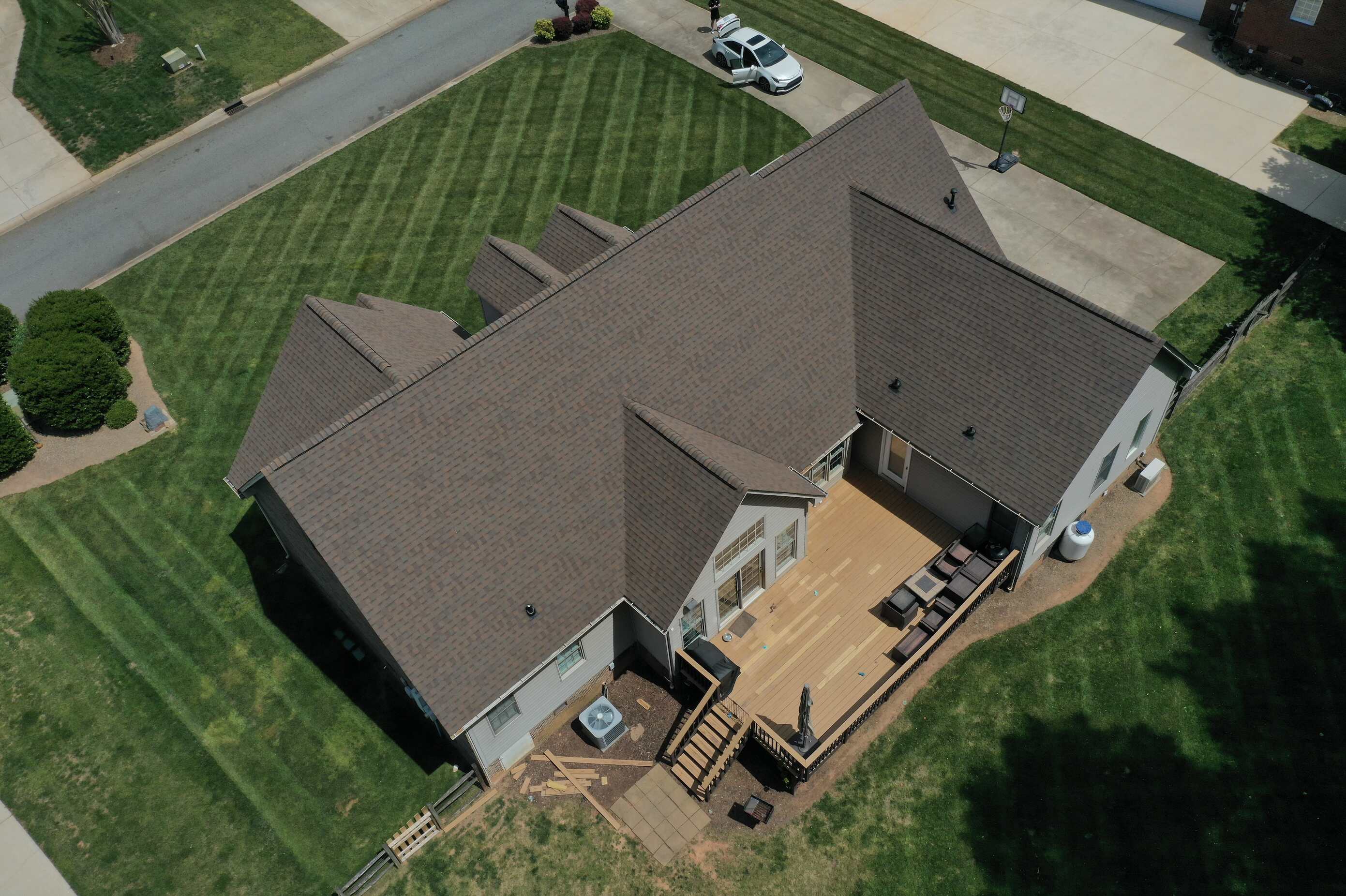 Rear view of a complete asphalt shingle roof installation on a Lake Norman home by Catawba Valley Roofing.
