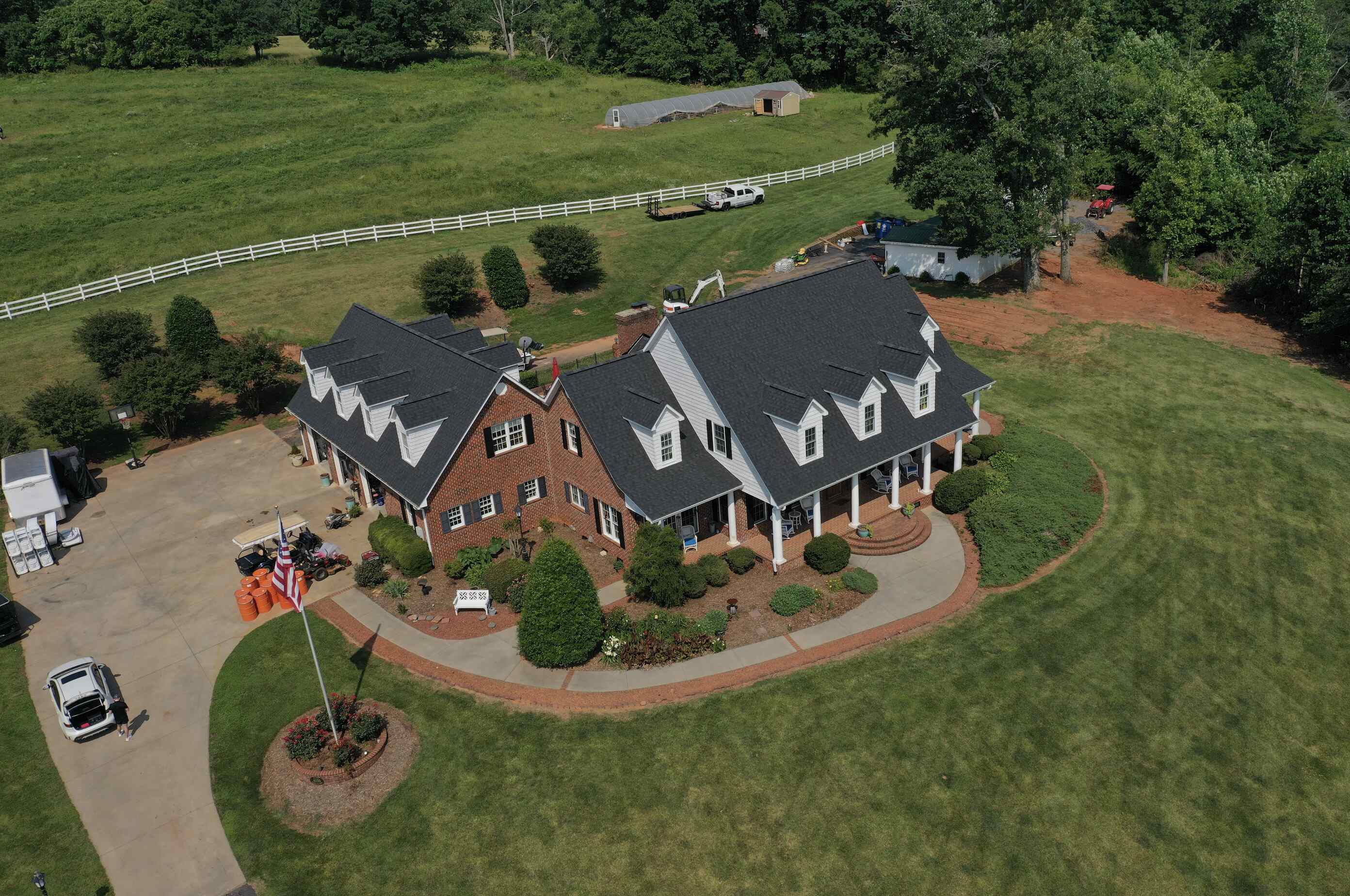 Front view of a newly installed asphalt shingle roof on a farmhouse in Hickory NC by Catawba Valley Roofing