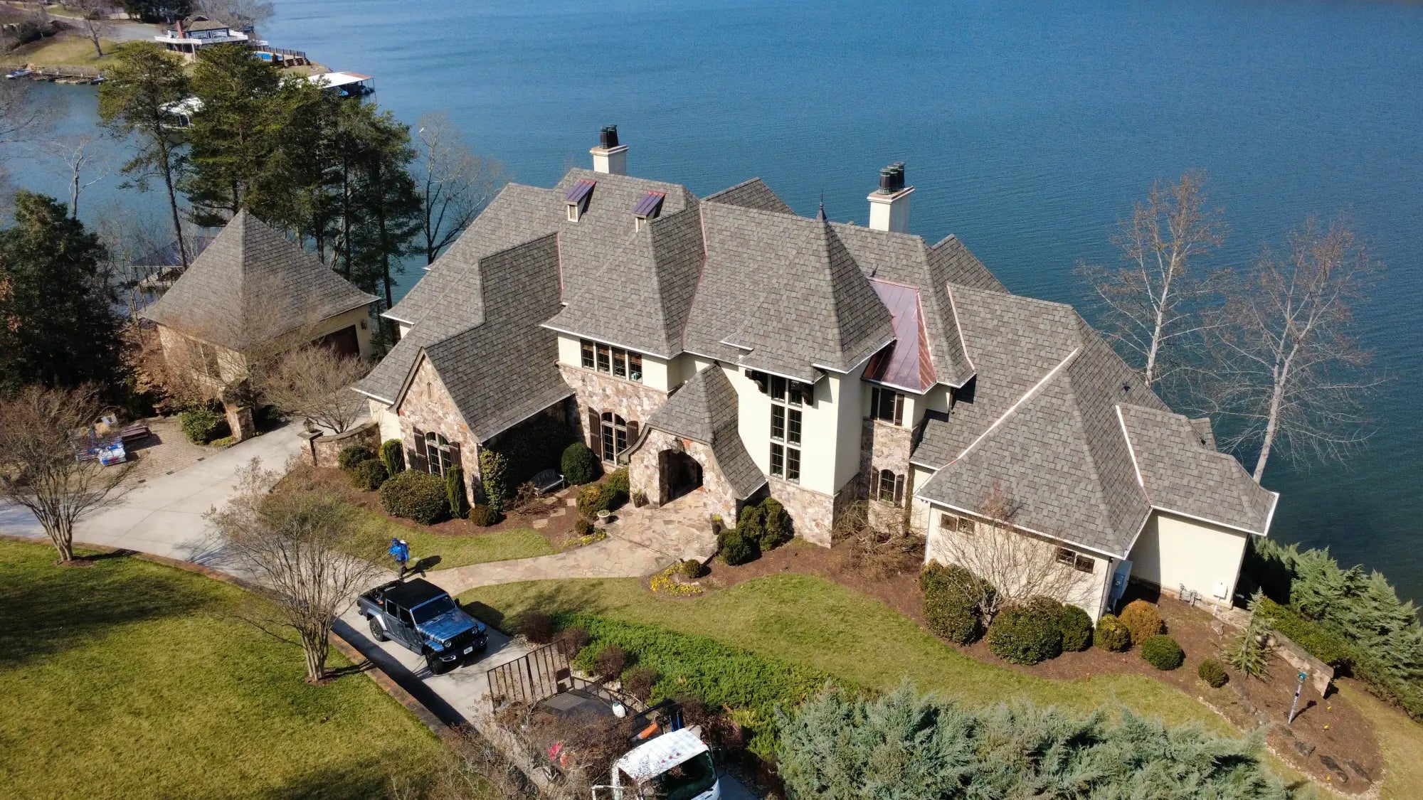 Front of a large mansion with a new roof in Hickory NC. Installed by Catawba Valley Roofing & Restoration - A local roofing company in Hickory NC