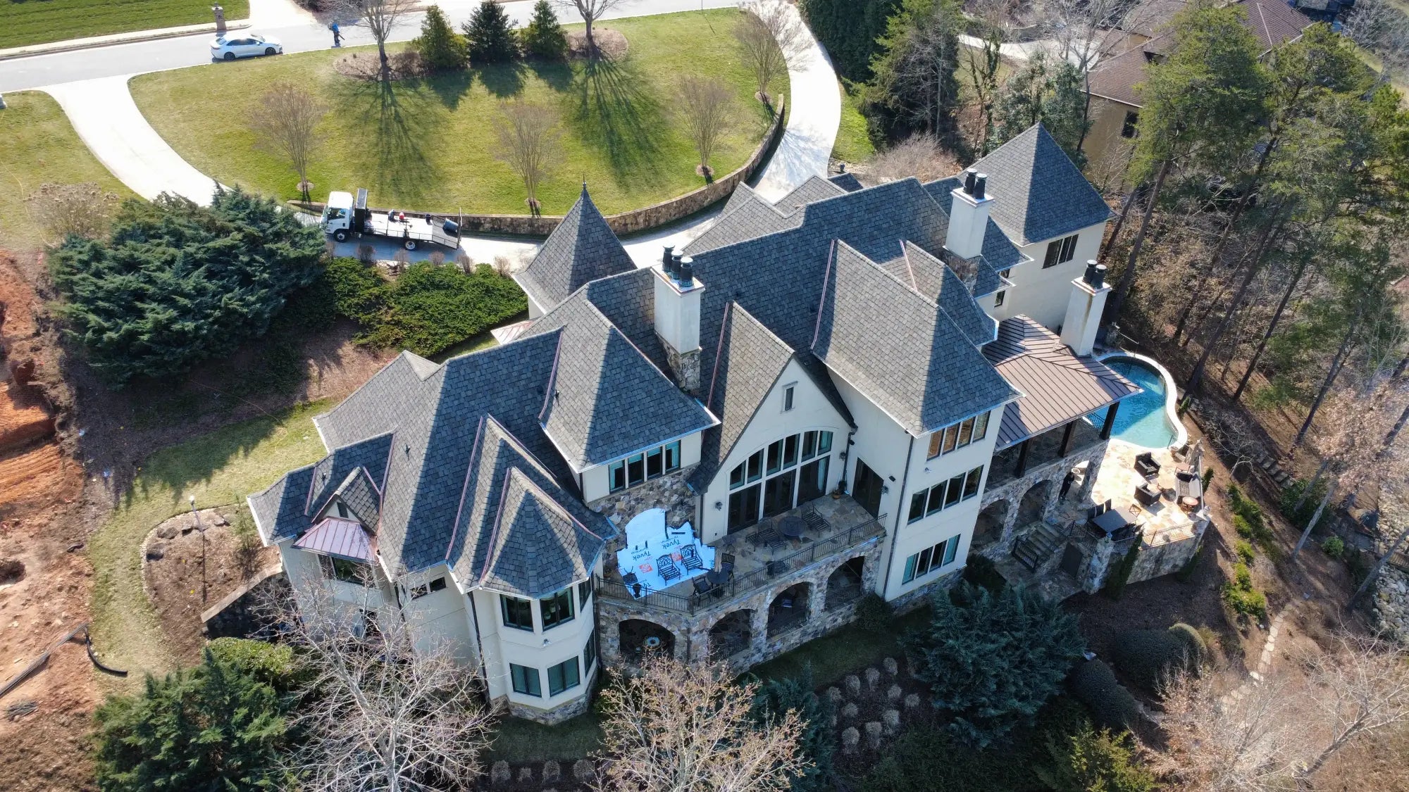 Back of a large mansion with a new roof in Hickory NC. Installed by Catawba Valley Roofing & Restoration - A local roofing company in Hickory NC