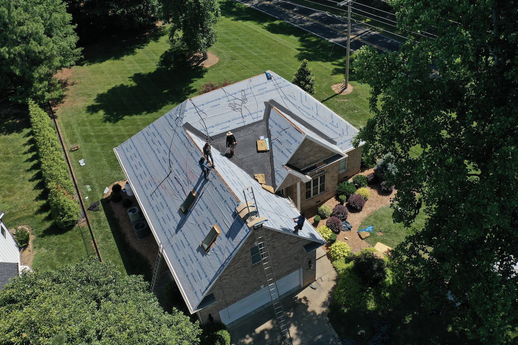 Aerial view of a house with a new roof under construction near Lake Norman, NC